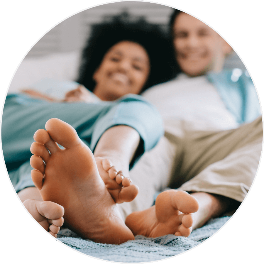 Couple sat with their feet up relaxed feeling better after foot treatment