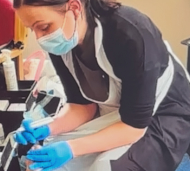 Practitioner treating a client in a care home.